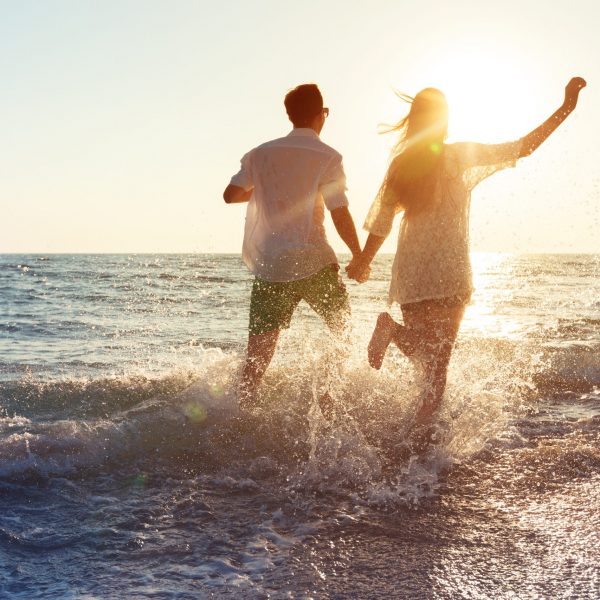 Happy young couple enjoying the sea